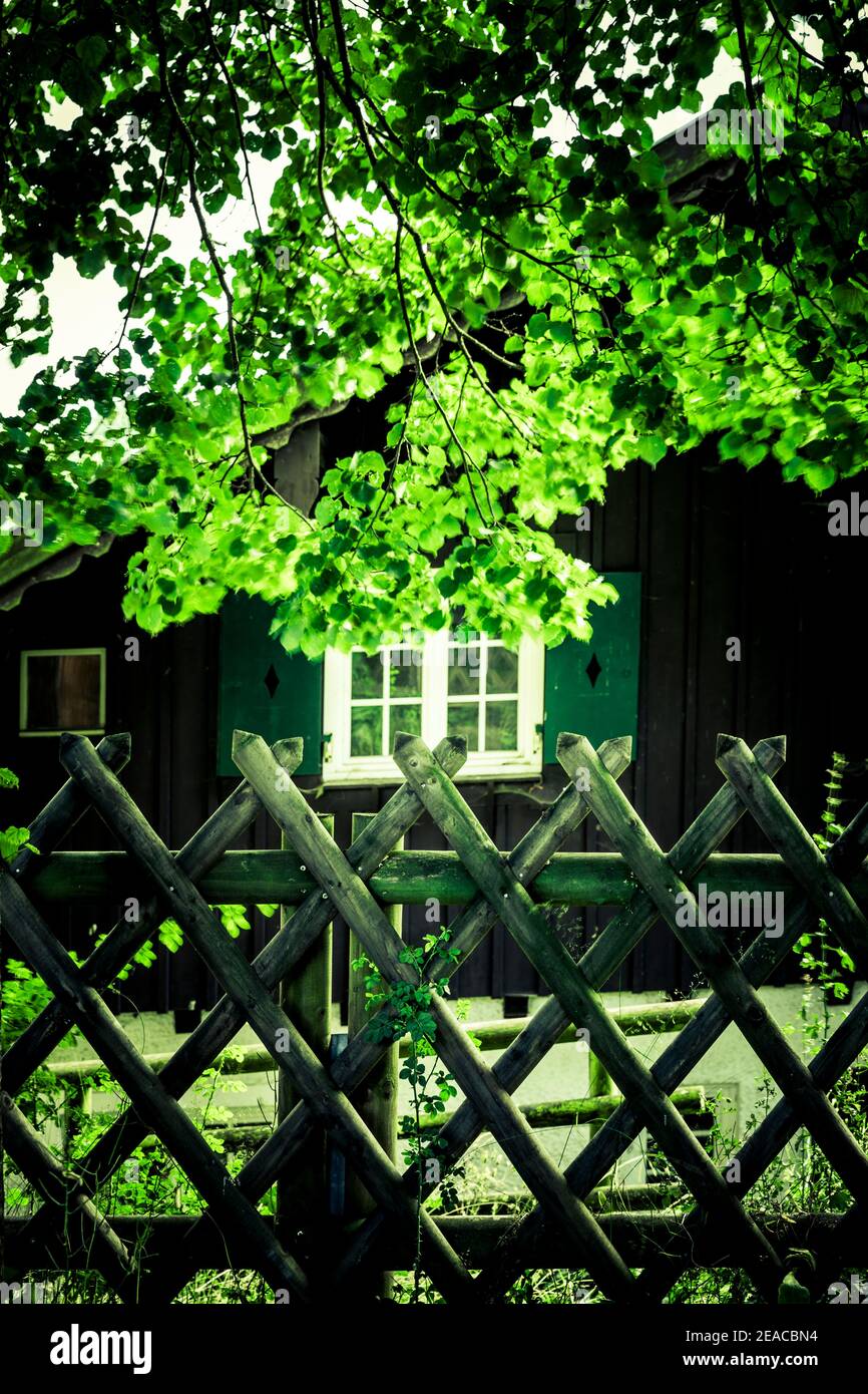 Hunters fence in front of an old wooden house hires stock photography