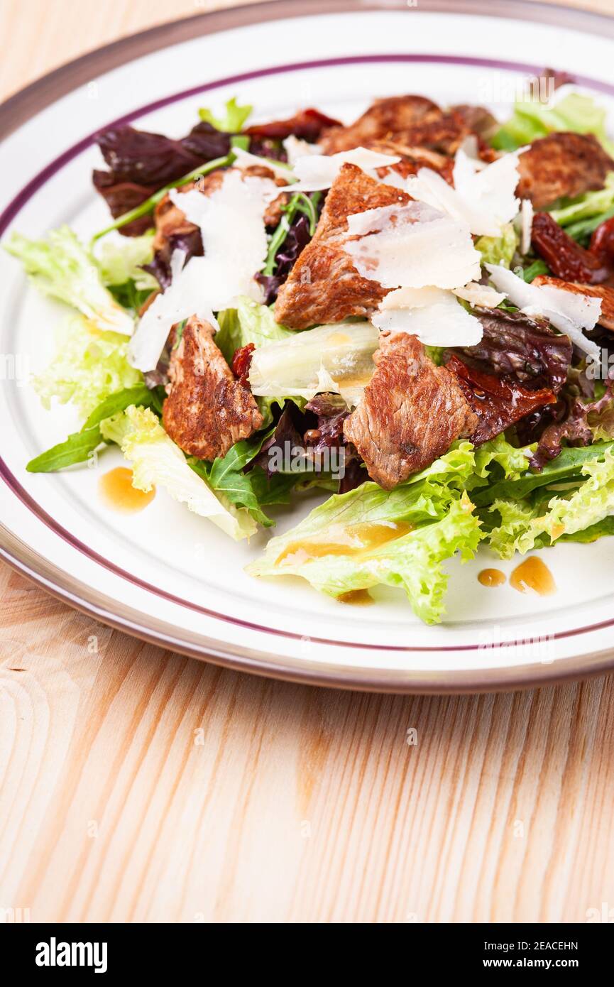 Fresh salad with meats in white plate Stock Photo