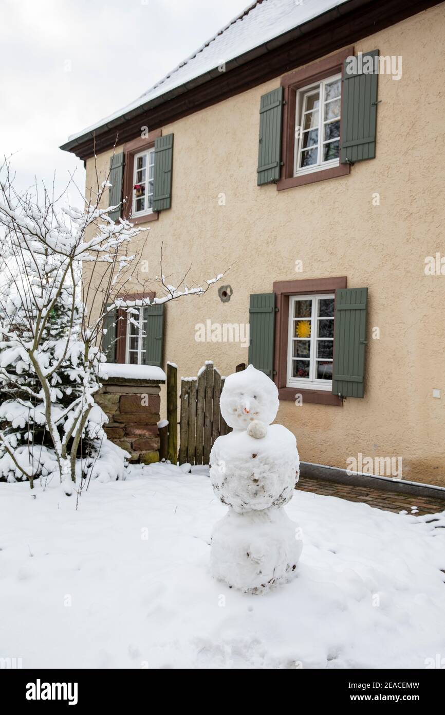 Snowman in front of the monastery building Stock Photo