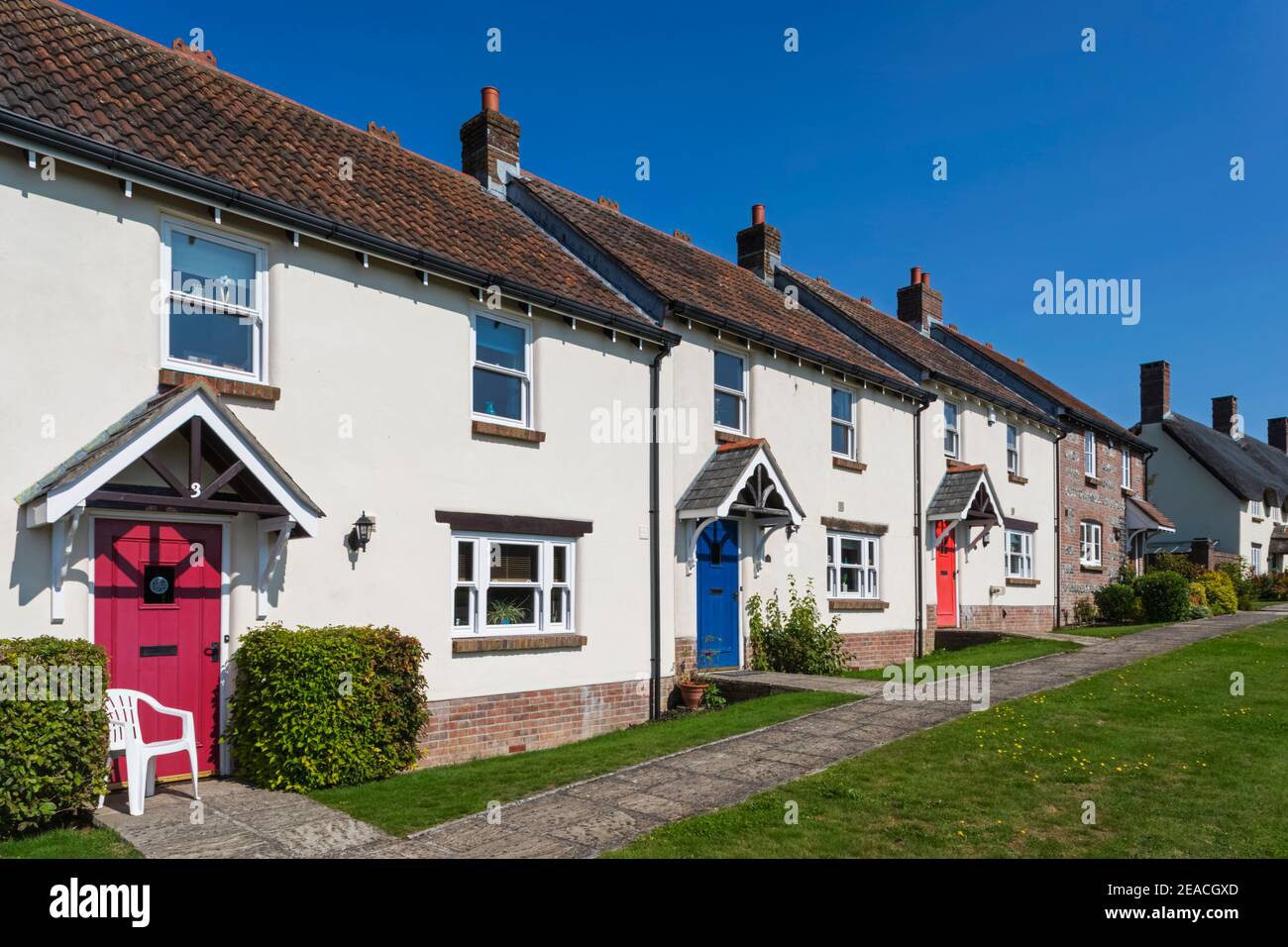 England, Dorset, Tolpuddle, Row of Houses with Colourful Doors Stock Photo