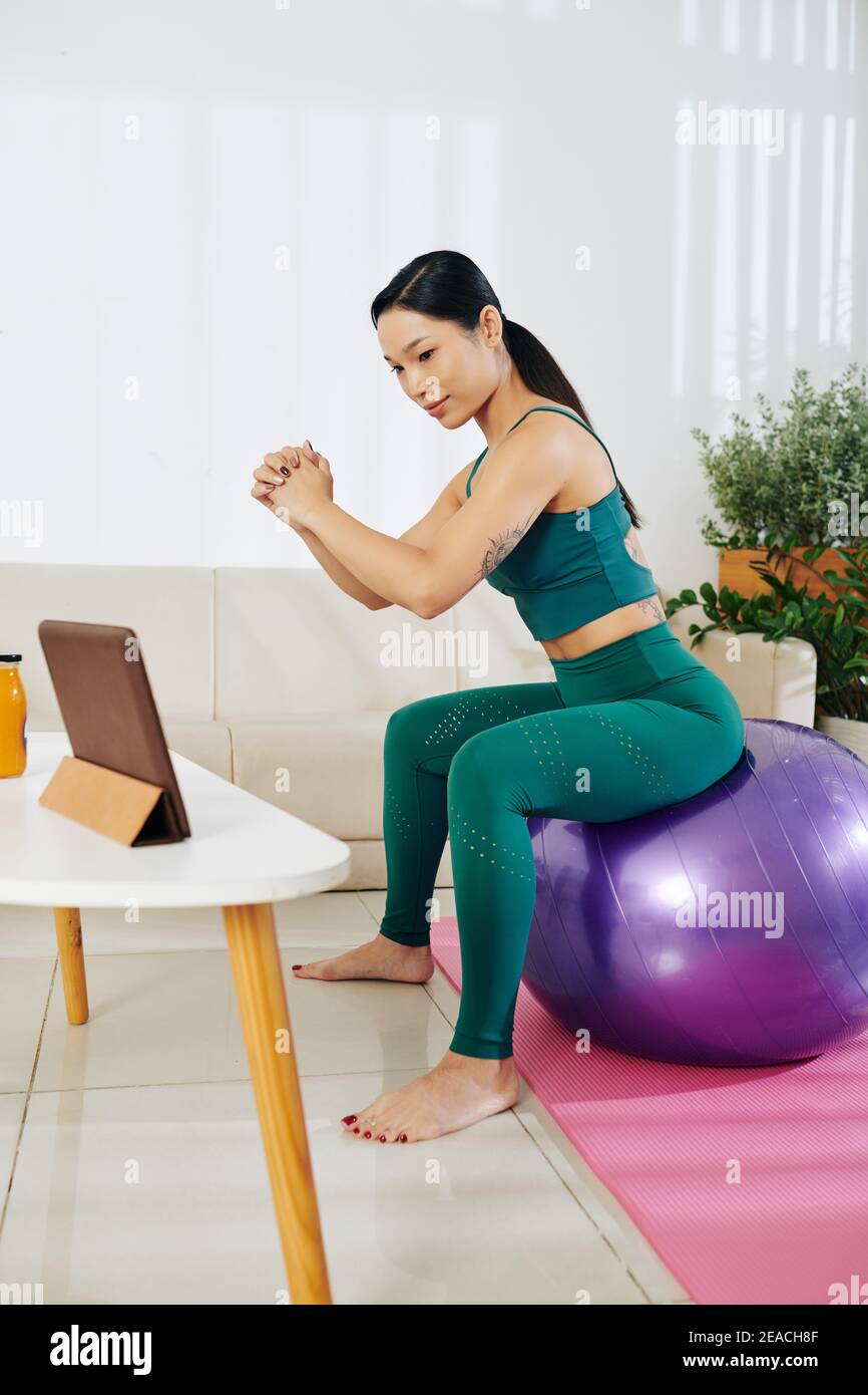 Woman doing fitball squats Stock Photo
