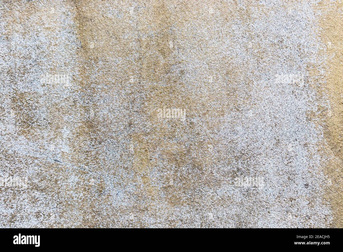 Th elements created various discoloration on a once white, stone wall to turn it into a perfect grungy background. Stock Photo