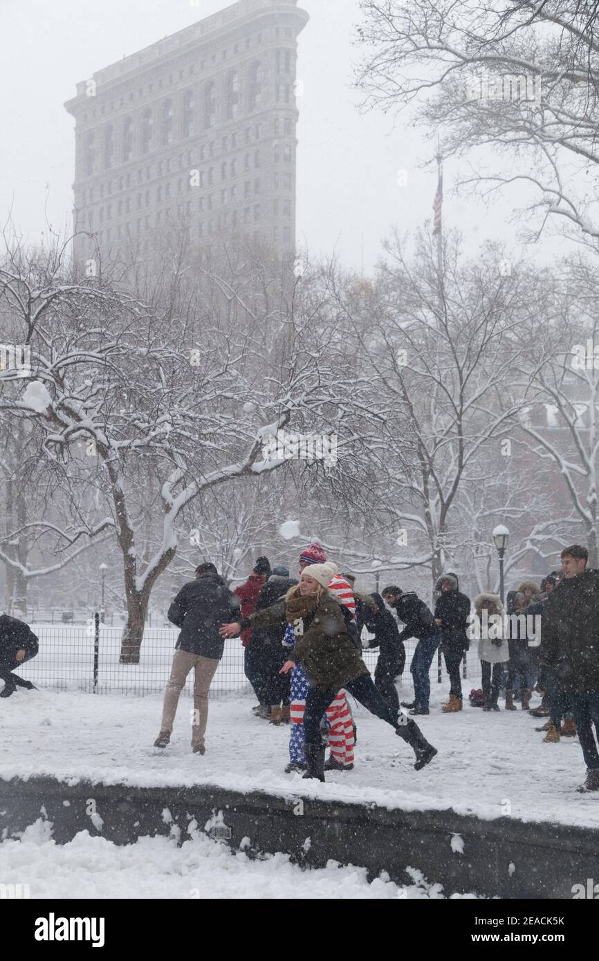New York City, USA A snowball fight in Madison Sqaure Park below The ...
