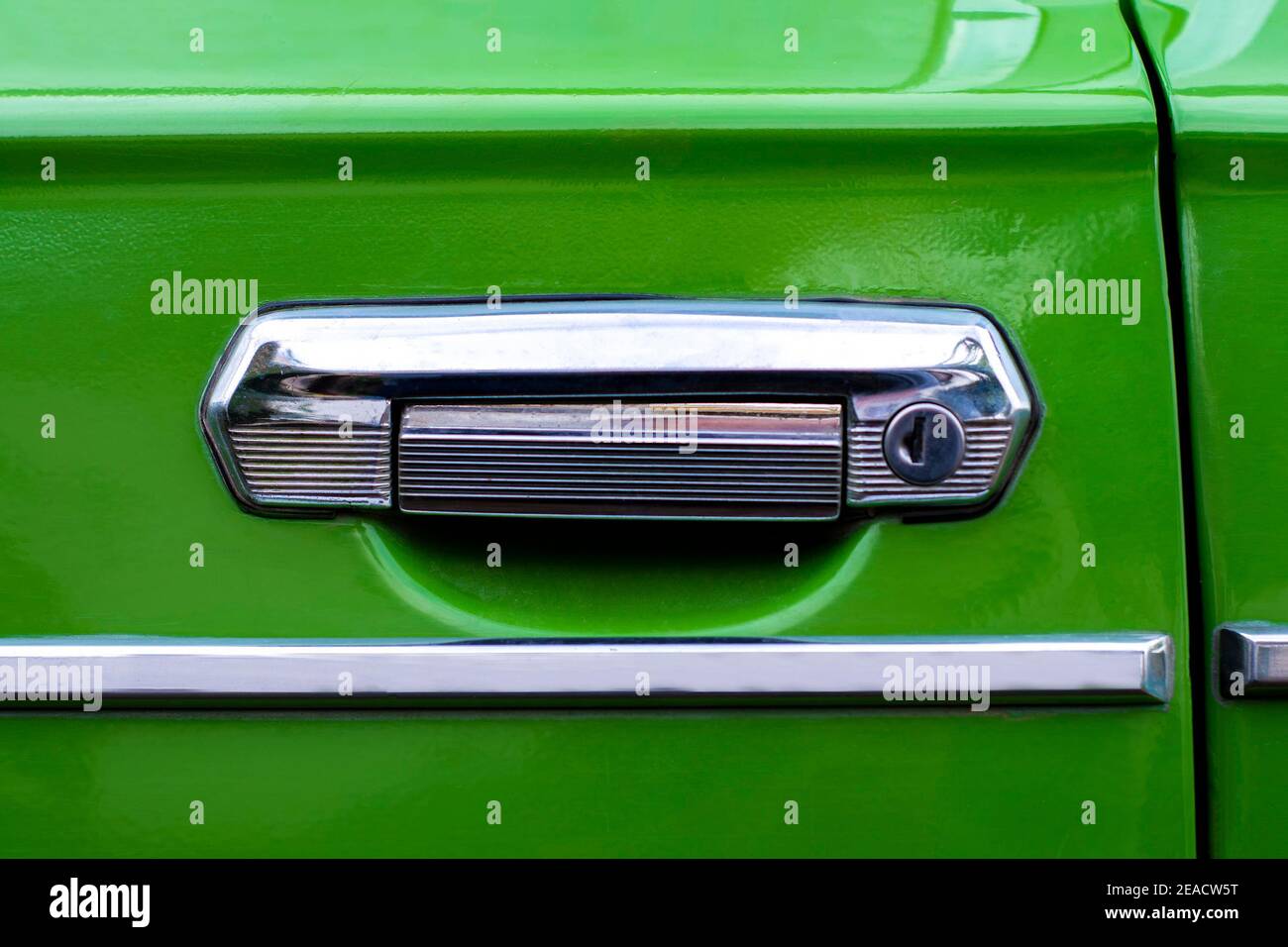 Iron handle door of old Soviet car. View from the front. The body is green. Kurskoe, Crimea - 4 October, 2020 Stock Photo
