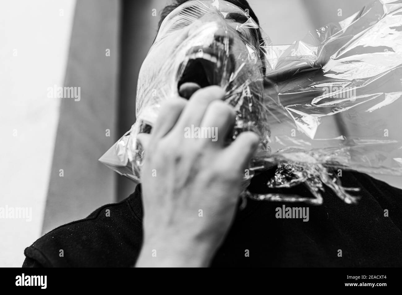 A Caucasian man with suffocation and anger wearing a plastic bag on his  head and shouting Stock Photo - Alamy