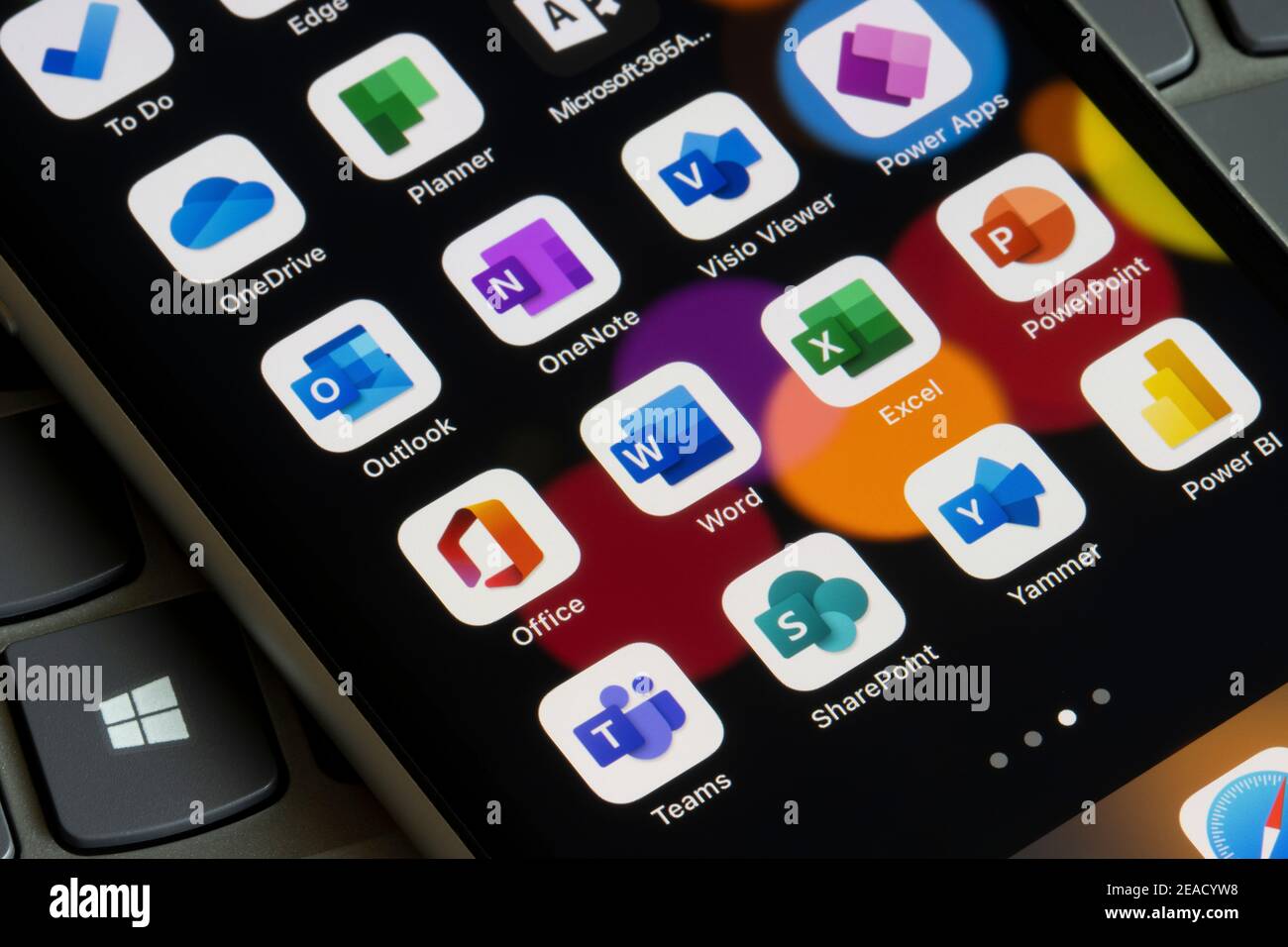 Microsoft 365 apps are seen on an iPhone - Office, Word, Excel, PowerPoint, Outlook, OneNote, Visio Viewer, Power Apps, Teams, SharePoint, Yammer, etc. Stock Photo