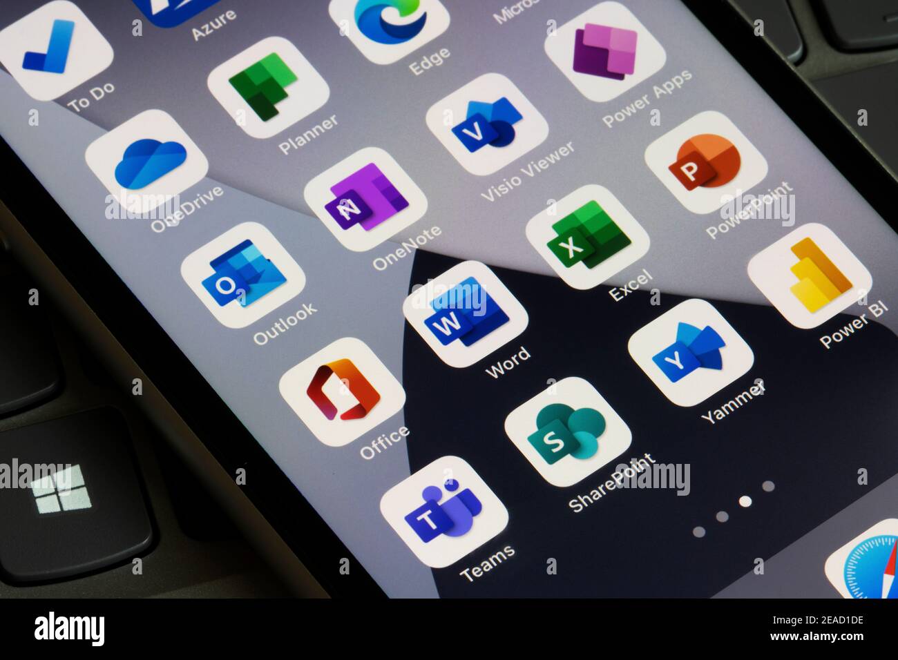 Microsoft 365 apps are seen on an iPhone - Office, Word, Excel, PowerPoint, Outlook, OneNote, Visio Viewer, Power Apps, Teams, SharePoint, Yammer, etc. Stock Photo