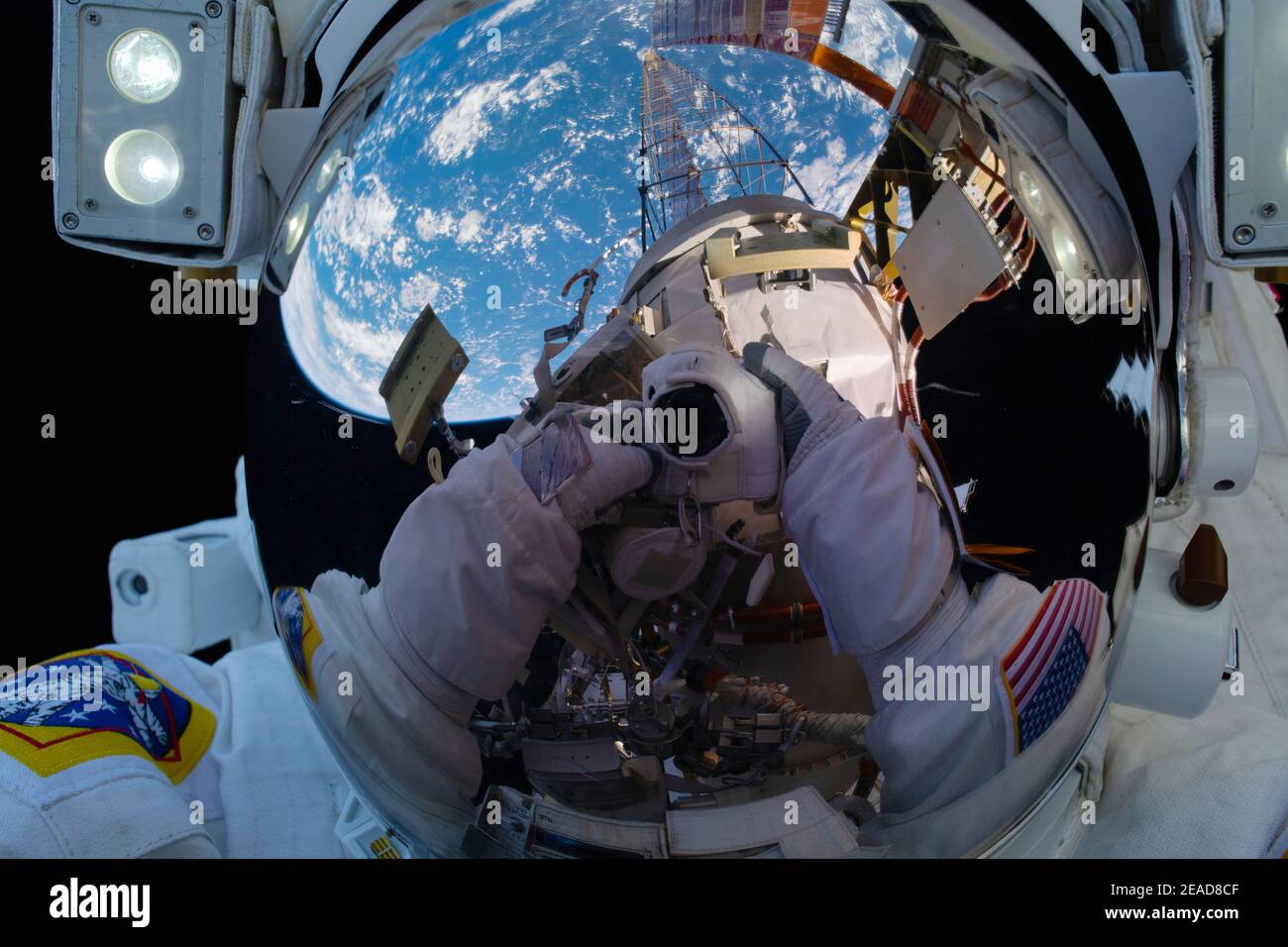 ISS - 1 February 2021 - NASA astronaut Michael Hopkins points his camera, insulated from the harmful environment of space, toward his spacesuit helmet Stock Photo
