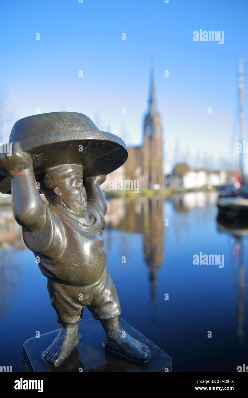 WEESP, NETHERLANDS - JANUARY 09, 2021: De Weesper Mop statue, located on  Binnenveer street and with Saint Lawrence (Laurentius) church in background  Stock Photo - Alamy