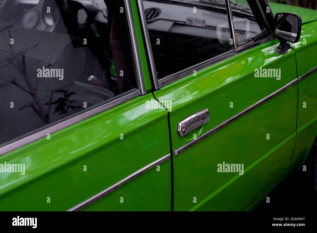 The side of the Soviet car. Side view. The body is green. Kurskoe, Crimea - 4 October, 2020 Stock Photo