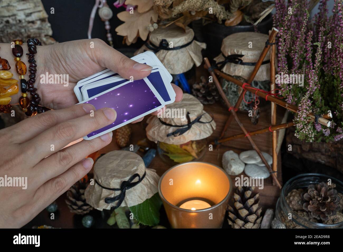 Woman hand is holding deck of tarot or oracle cards doing Stock Photo Alamy