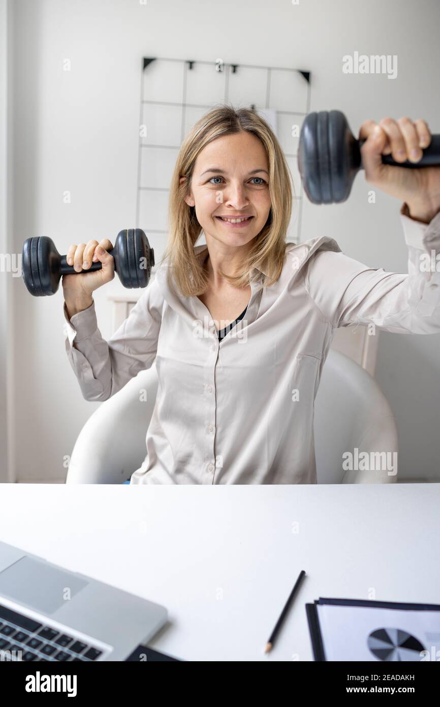 Work Life Balance: Business woman working and doing sport in her office ...