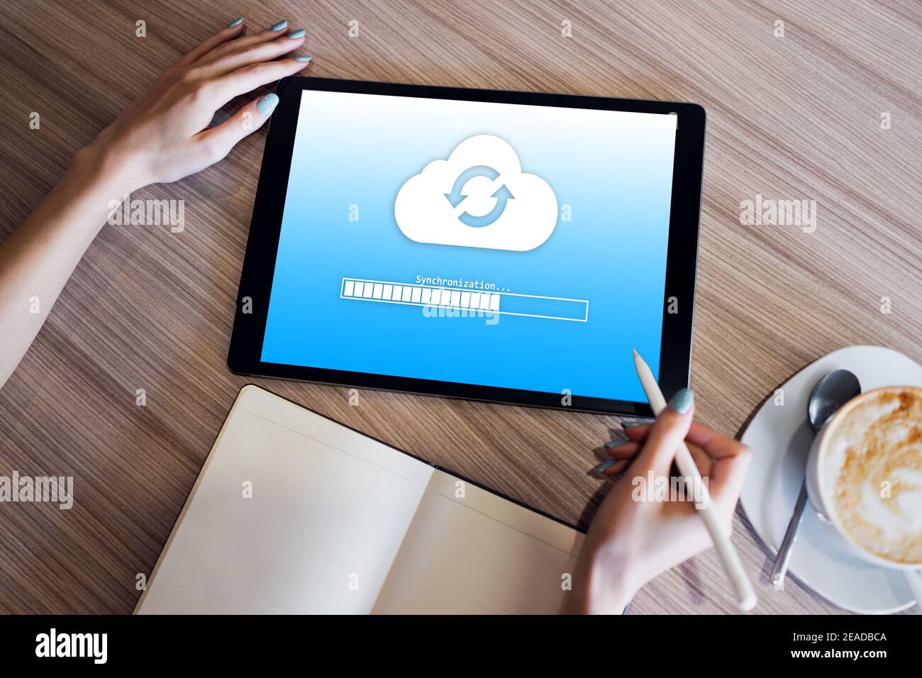 Cloud synchronization progress bar on tablet screen. Data storage and protection. Technology and internet concept Stock Photo