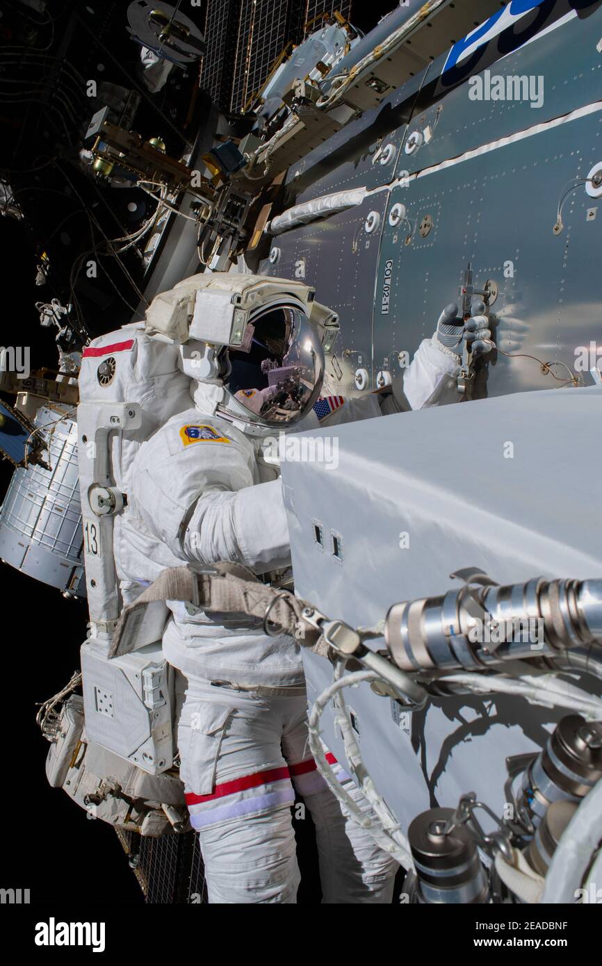 ISS - 27 January 2021 - Jan. 27, 2021) --- NASA astronaut Michael Hopkins is pictured attached to Europe's Columbus laboratory module installing a sci Stock Photo