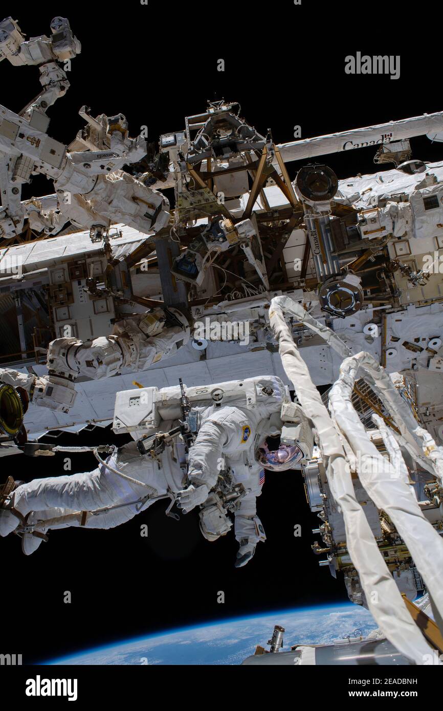 ISS - 27 January 2021 - NASA astronaut Victor Glover is pictured attached to the Canadarm2 robotic arm during a spacewalk that lasted six hours and 56 Stock Photo