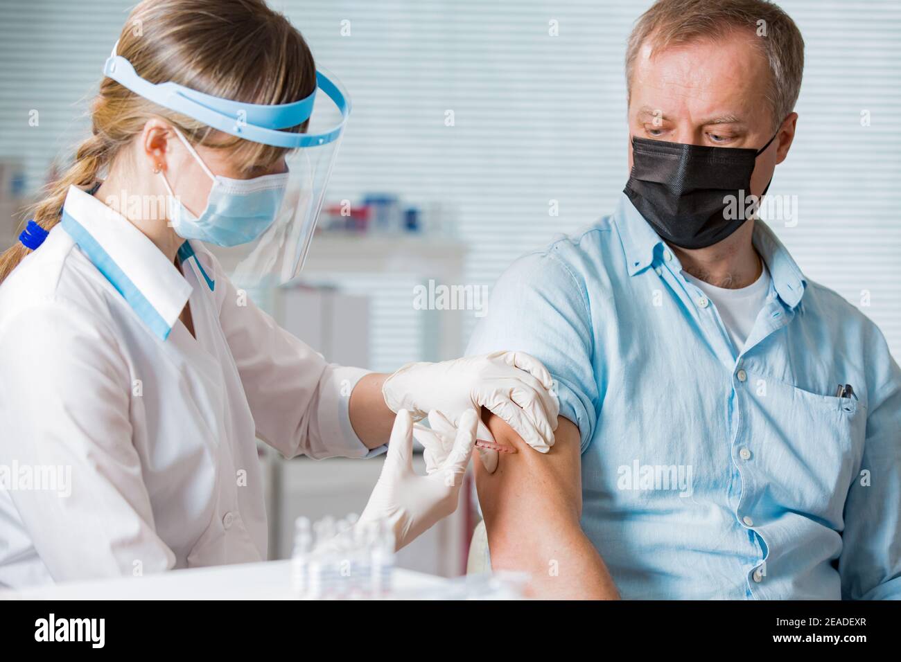 Doctor giving woman injection hi-res stock photography and images - Alamy