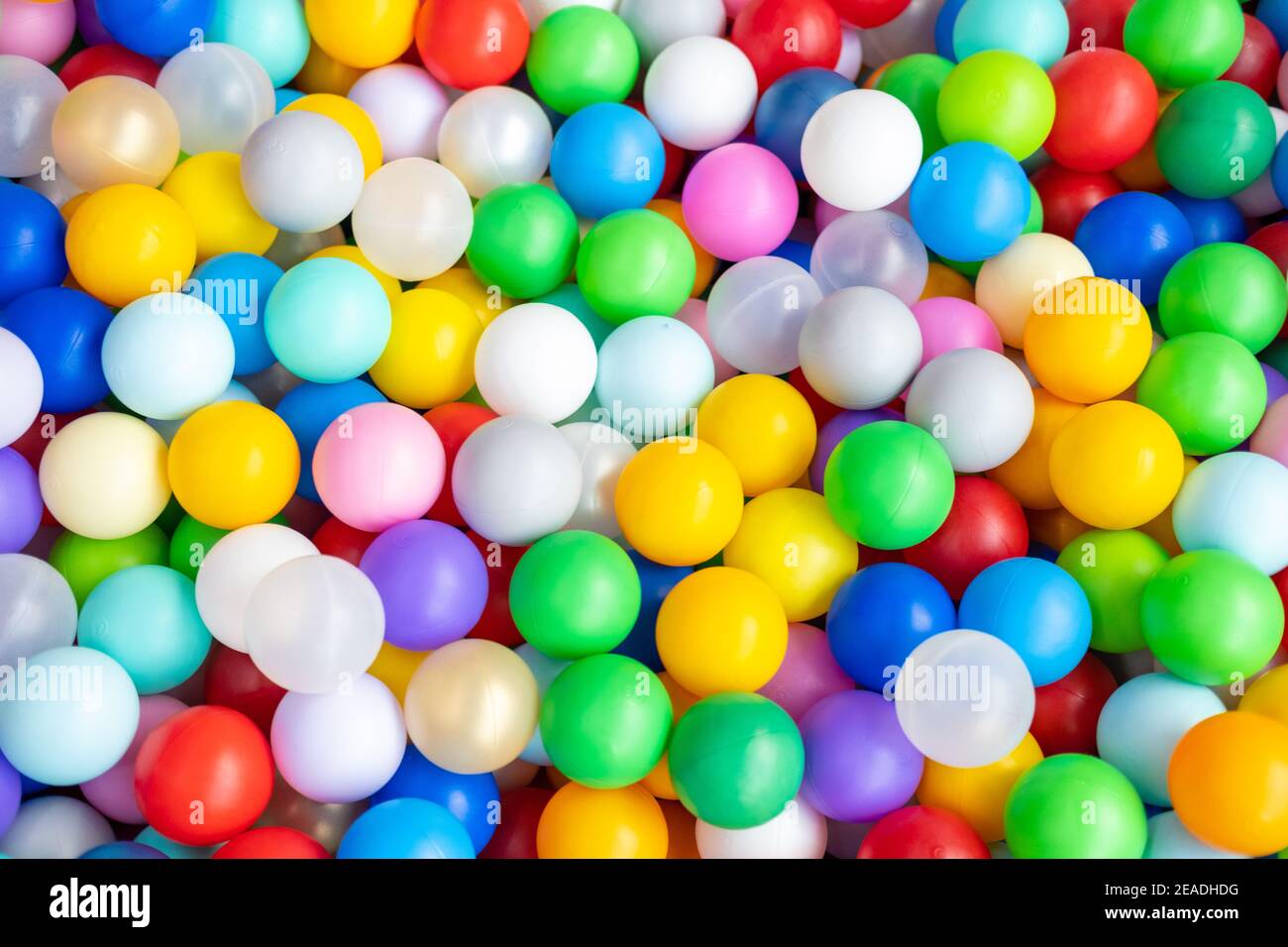 Multi coloured plastic balls in big dry paddling pool in playing centre