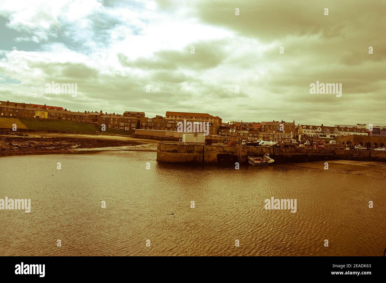 Seahouses Northumberland harbour houses wall town village sky clouds