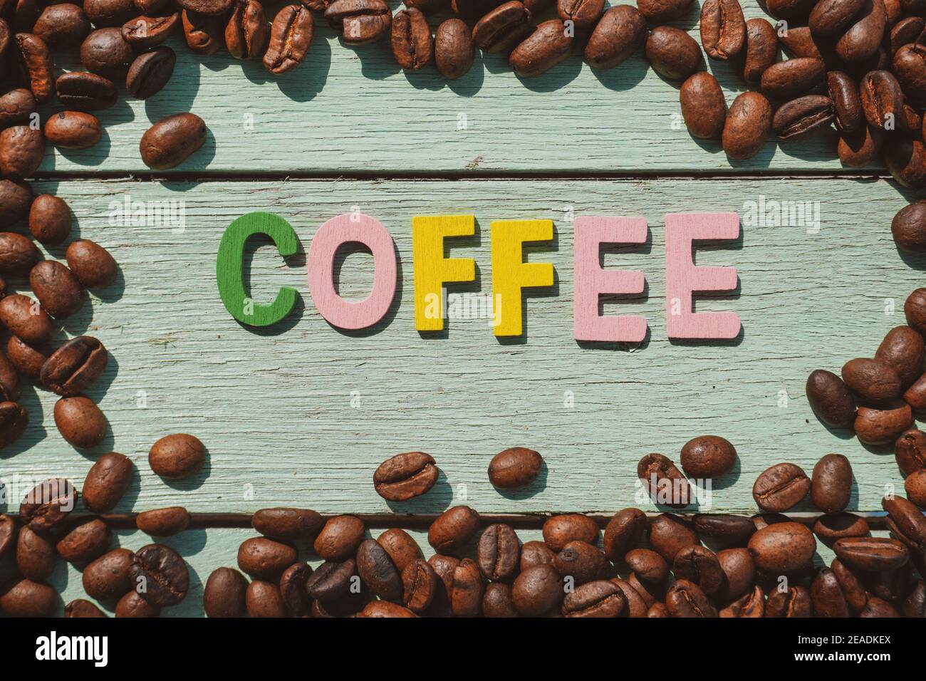 Coffee Day alphabets form on roasted coffee beans background. Stock Photo