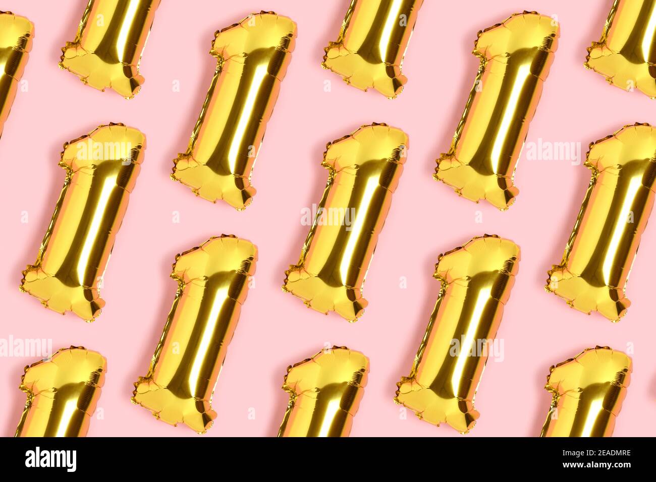 Number 1 golden balloons pattern. One year anniversary celebration concept on a pink background. Stock Photo