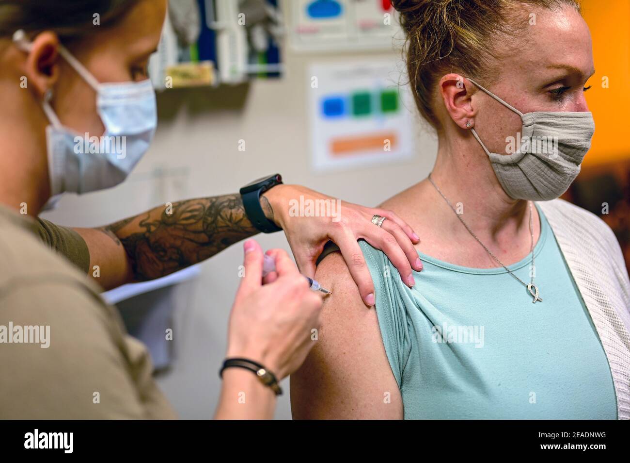 PITTSBURGH, USA - 28 January 2021 - Master Sgt. Luca Farkas, 911th Aeromedical Staging Squadron aeromedical technician, administers a COVID-19 vaccine Stock Photo