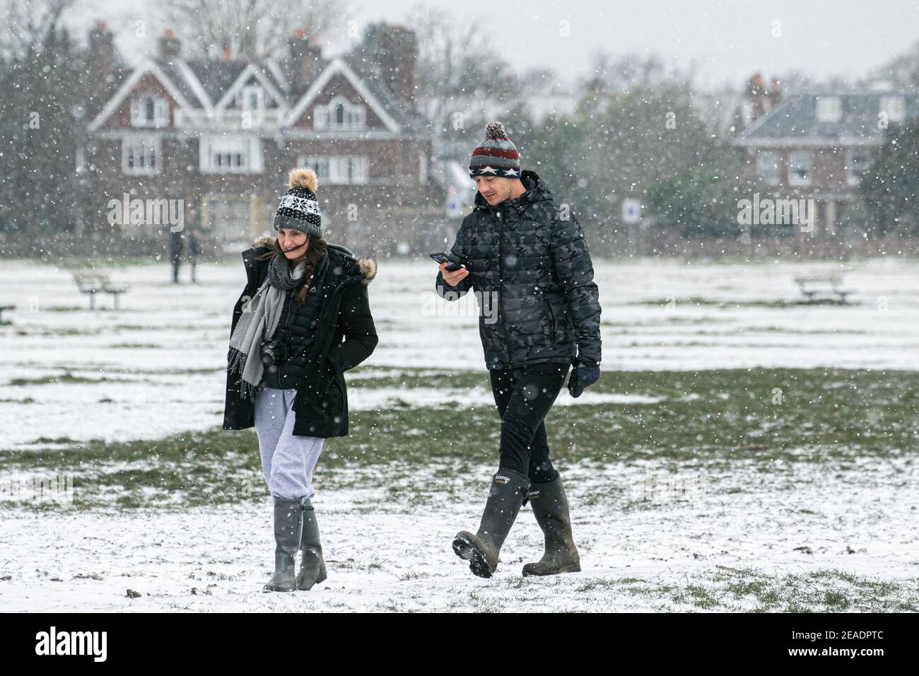 Wimbledon London Uk 9 February 21 People Walking During A Snow Shower This Morning On Wimbledon Common From The Effects Of Storm Darcy The Met Office Has Issued Yellow Snow And Ice