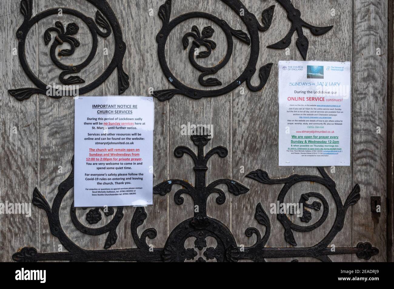 Covid 19 related notices posted on an ornate church door during the third UK lockdown, St Marys Church, Higham Ferrers, Northamptonshire. Stock Photo