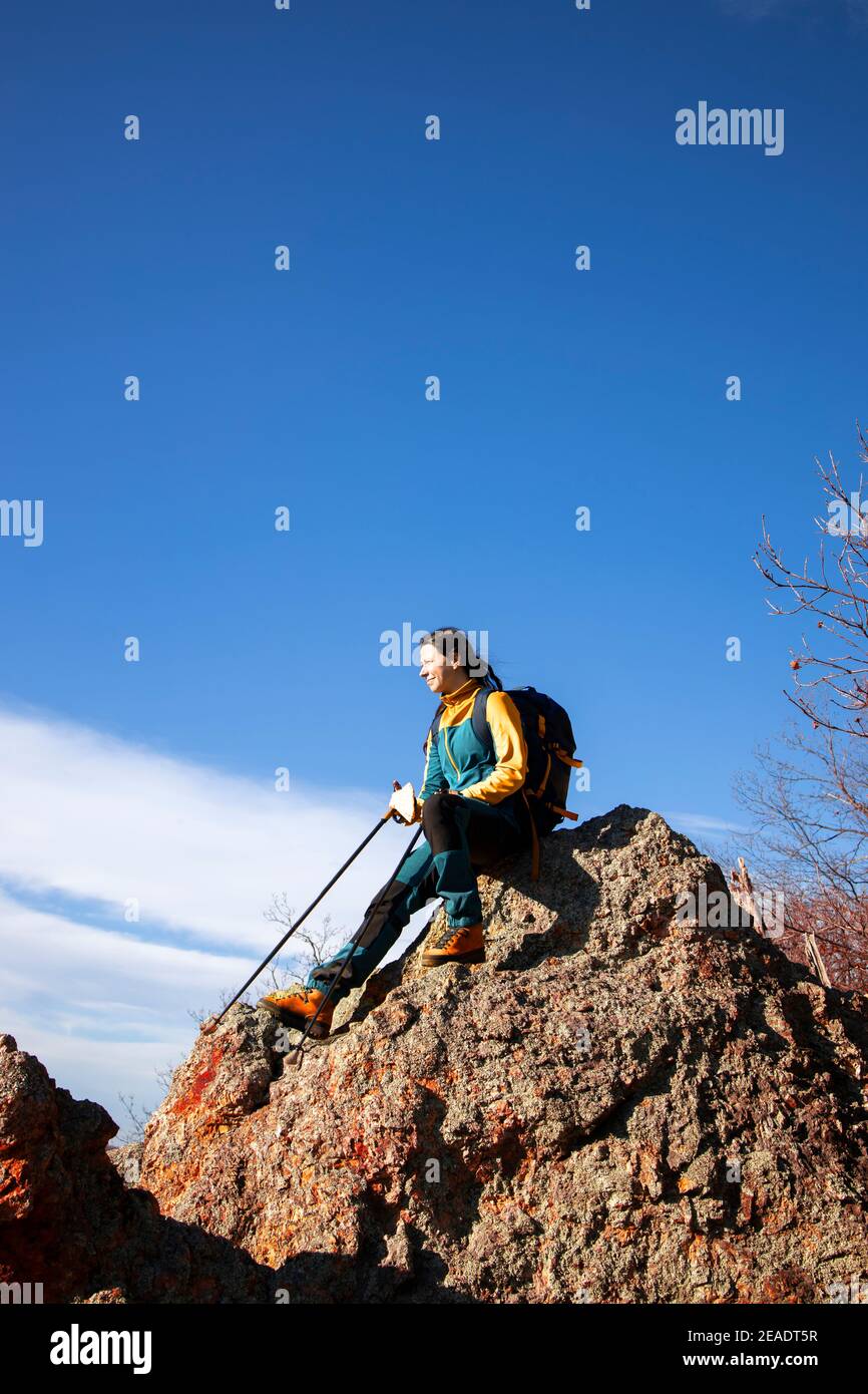 Resting On Rocks Woman resting on a rock during her hike in the beautiful outdoors Stock ...