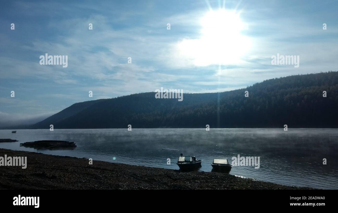 The Lena River. Fishing boats on the bank of the taiga river Stock Photo