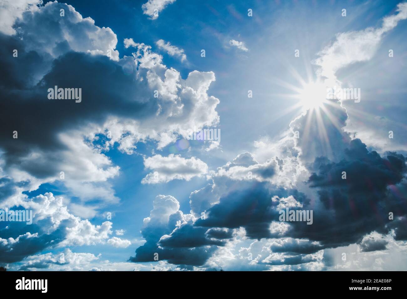 Blue sky background with clouds and sun Stock Photo - Alamy