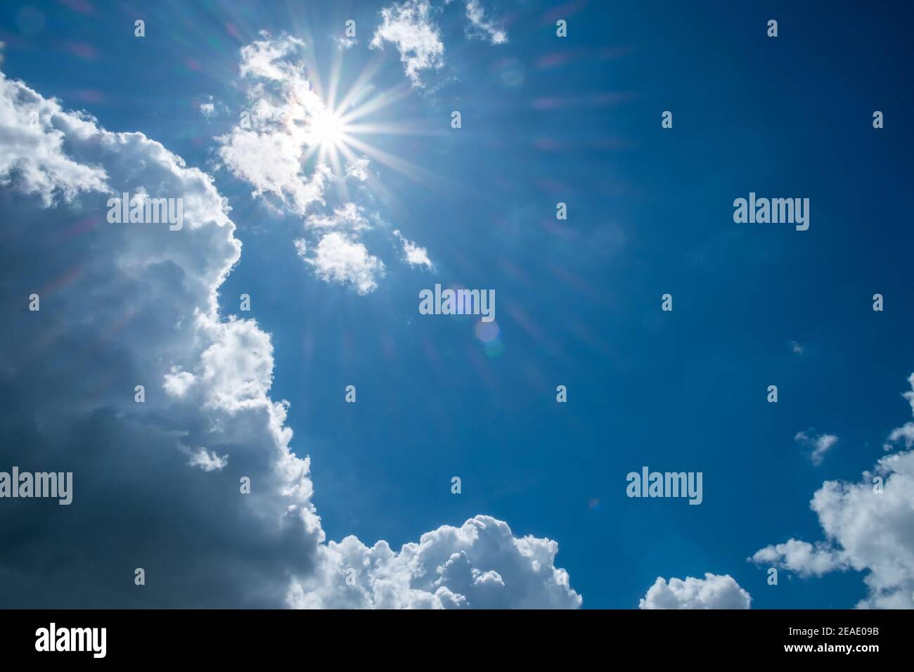 Blue sky background with clouds and sun Stock Photo - Alamy