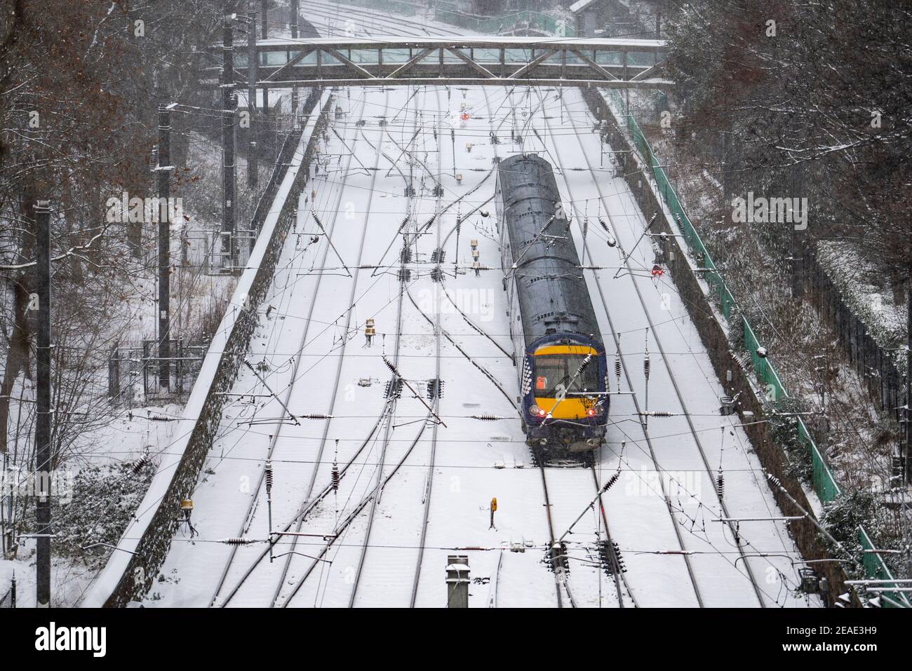 Edinburgh, Scotland, UK. 9 Feb 2021. Big freeze continues in the UK with Storm Darcy bringing several inches of snow to Edinburgh overnight. Pic; Train leaves Waverley Station. Iain Masterton/Alamy Live news Stock Photo