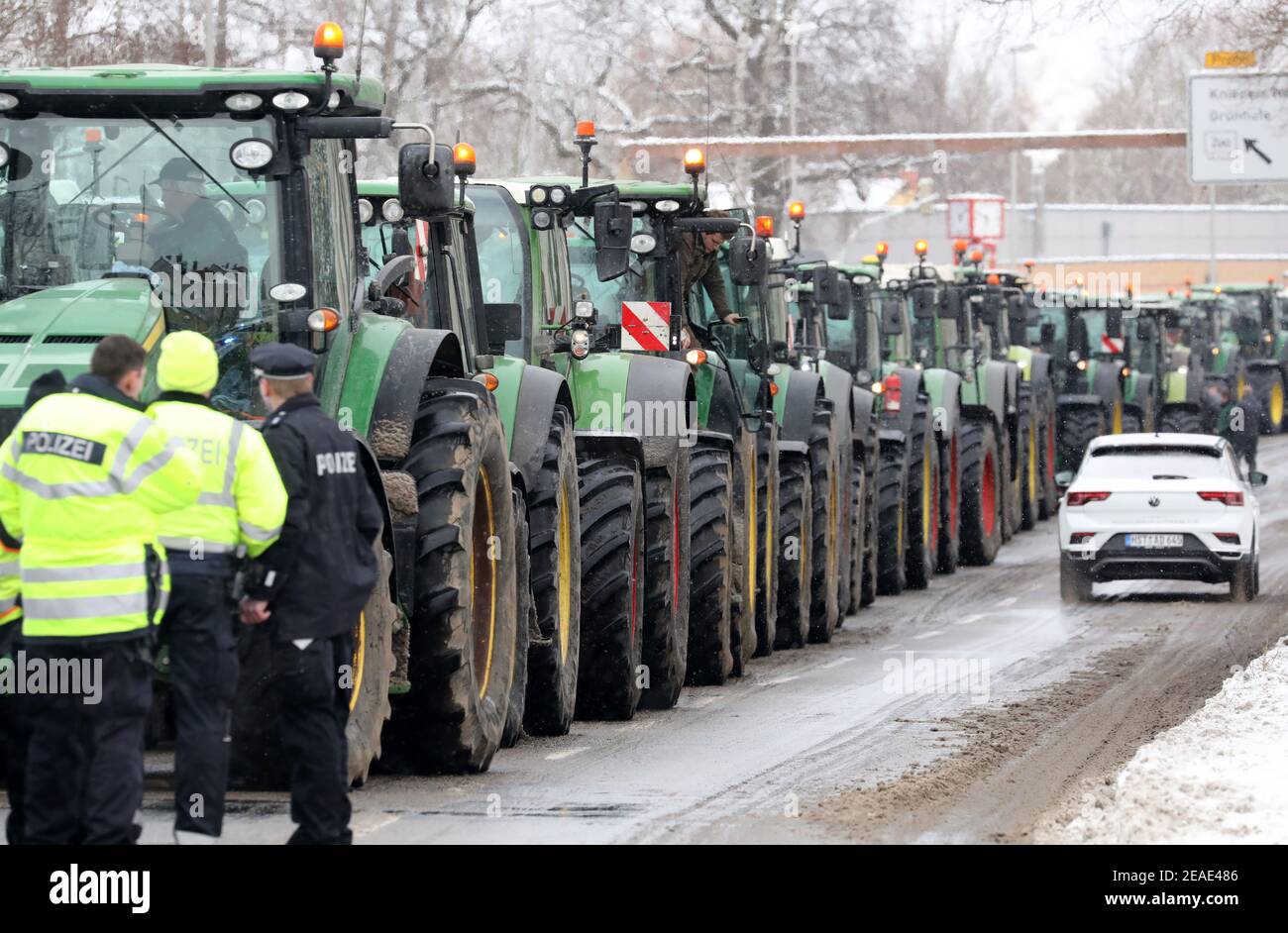 Stralsund, Germany. 09th Feb, 2021. Under police supervision, farmers protest against new environmental regulations with a parade of 206 tractors to the district administration office of Vorpommern-Rügen. The reason for the protest is the 'Action Programme for Insect Protection' planned by the Federal Government, which is to be adopted by the Federal Cabinet on 09.02.2021. Credit: Bernd Wüstneck/dpa-Zentralbild/dpa/Alamy Live News Stock Photo