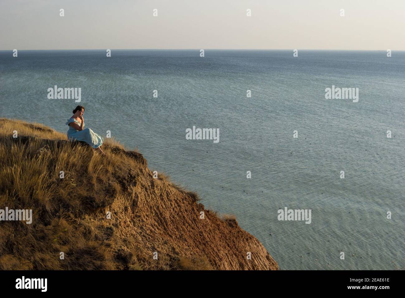 Girl sitting on edge cliff hi-res stock photography and images - Alamy