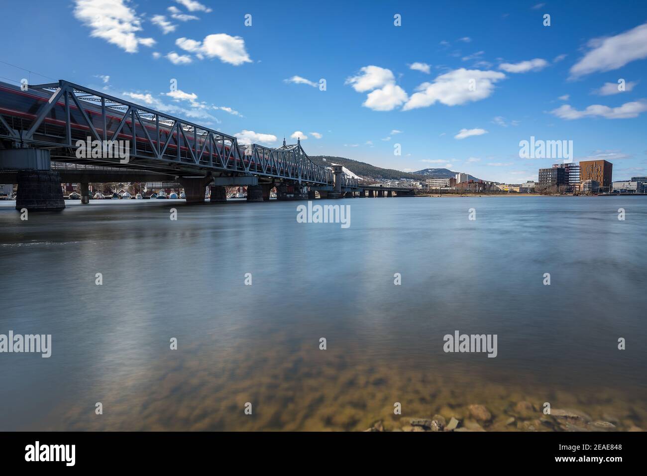 Railroad bridge in Drammen, Norway with a local train passing Stock Photo