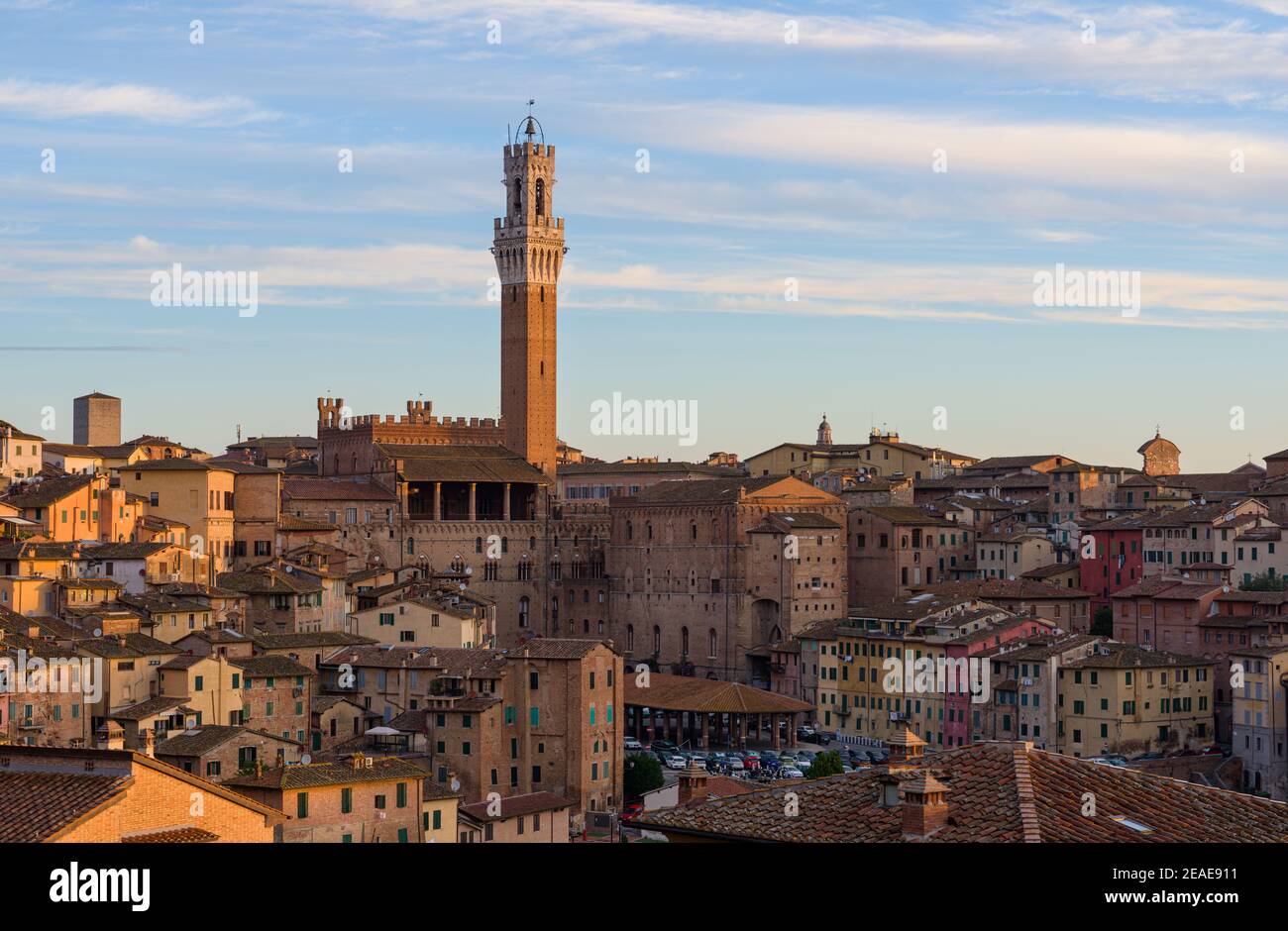 Siena old town at sunrise, a medieval and Renaissance city in Tuscany, Italy, with Mangia tower, church, old houses and palaces on a green hill Stock Photo