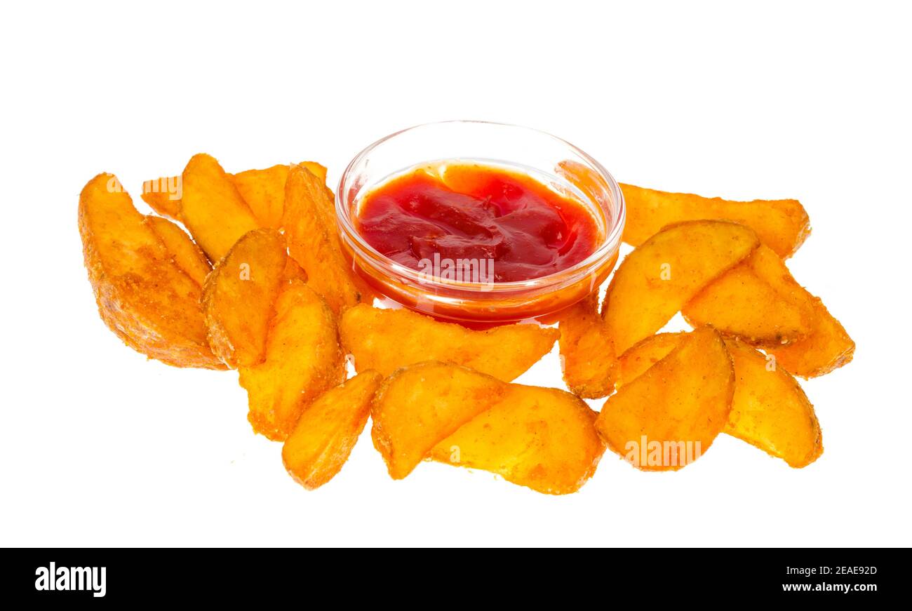 Rustic potato wedges and ketchup on white background. Studio Photo