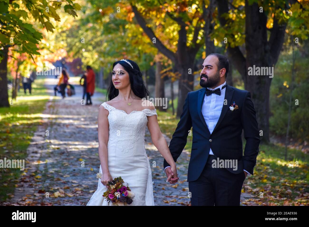 Beautiful wedding couple walking in park, Istanbul, Turkey Stock Photo