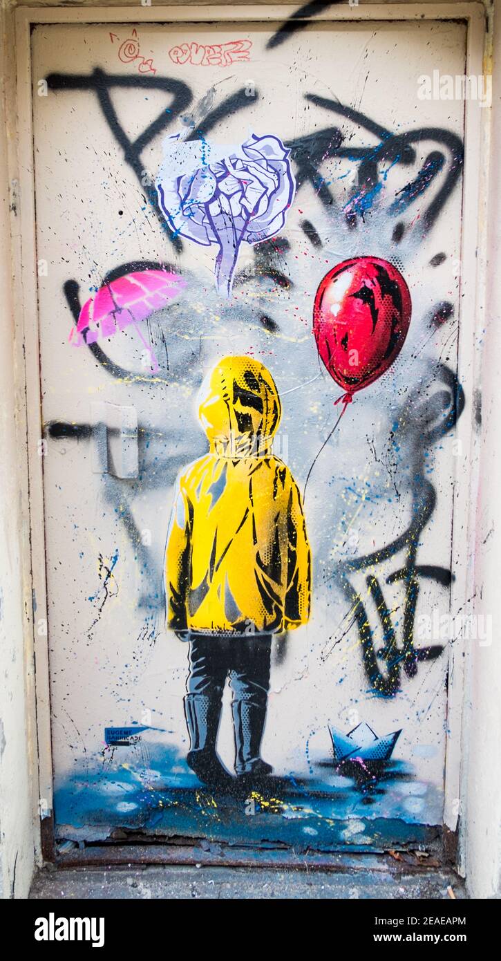 Paris - Street Art - Child in Yellow Raincoat with Red Balloon - Rue Lepic, Montmartre, Paris Stock Photo