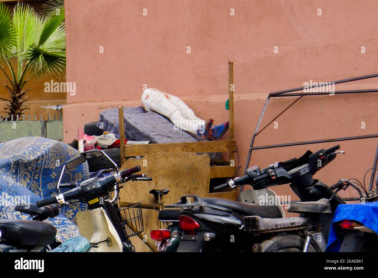Marrakesh run down neighbourhood rubbish tip with the lower half (white legs) of a tailor's dummy. Marrakesh, Morocco. Stock Photo