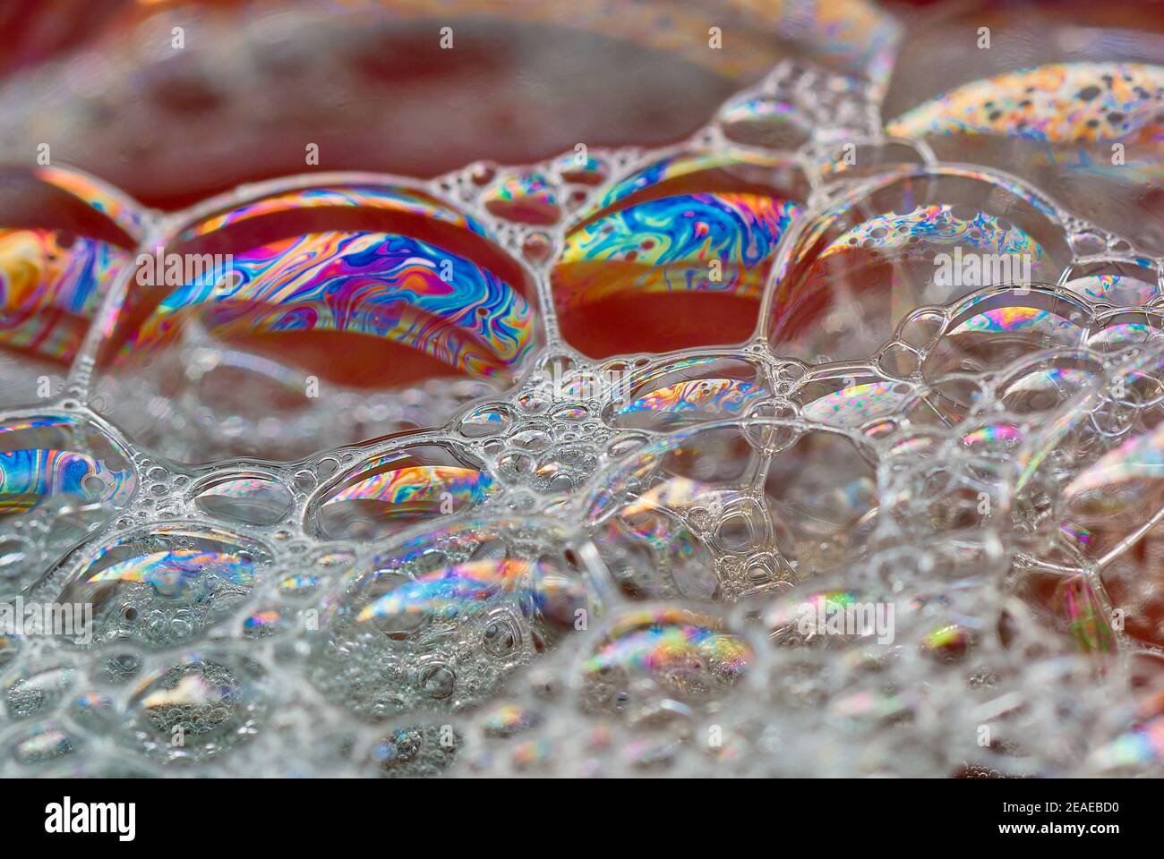 Large soap bubbles with a multicolor rainbow pattern. Floating on water ...