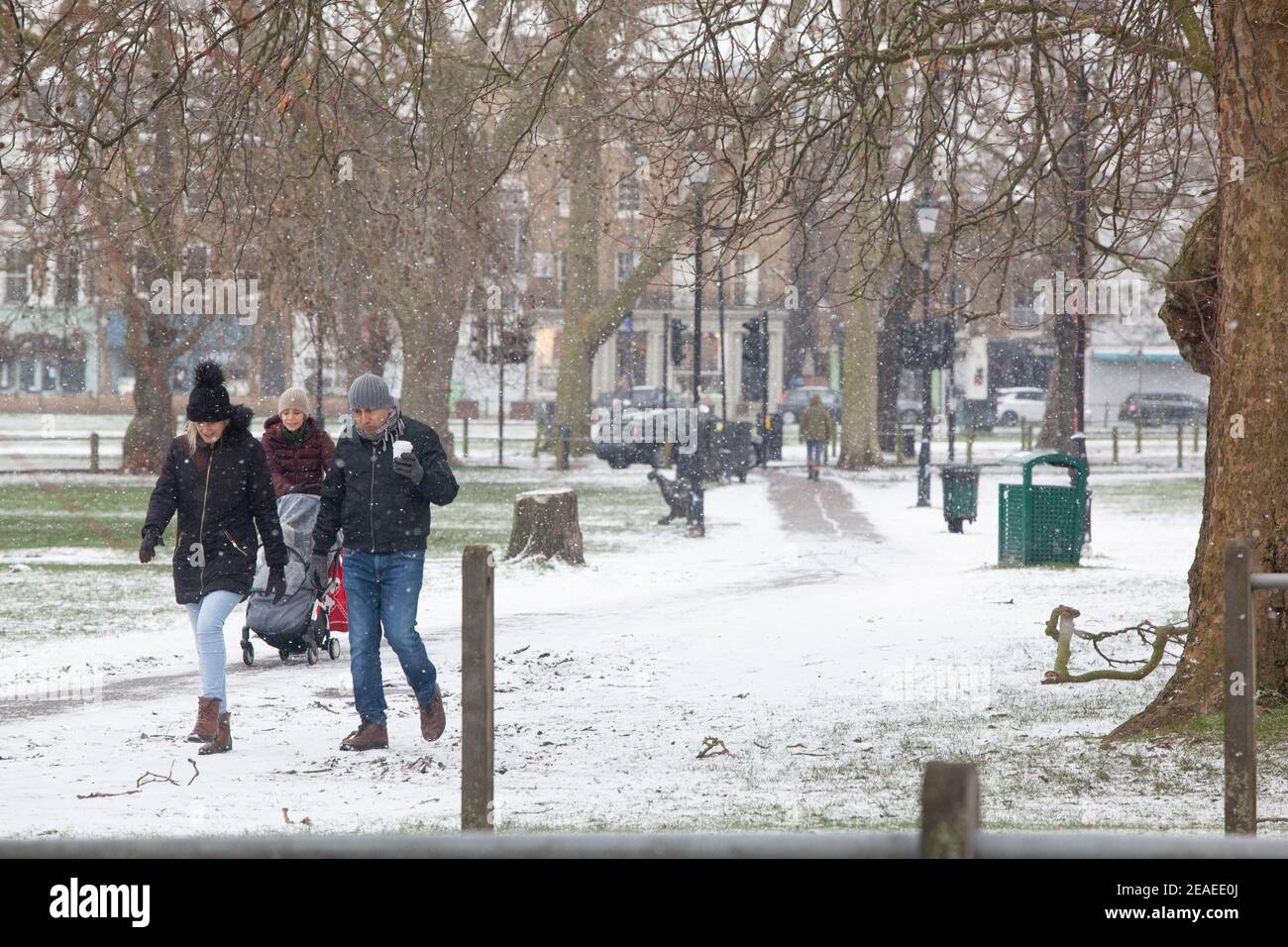 London, UK. 9 February 2021: After three days of snow in London it is starting to settle and winds have dropped as Storm Darcy has passed. On Clapham Common a few people take exercise. Credit: Anna Watson/Alamy Live News Stock Photo
