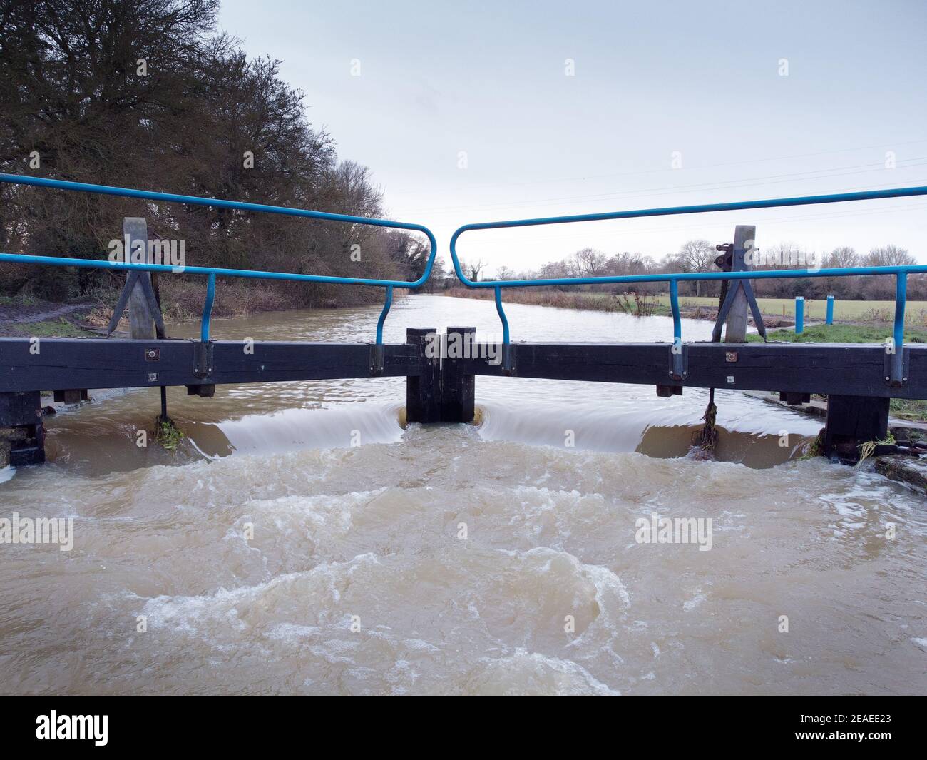 high water overflowing over a lock in essex englang after a lot of rainfall Stock Photo