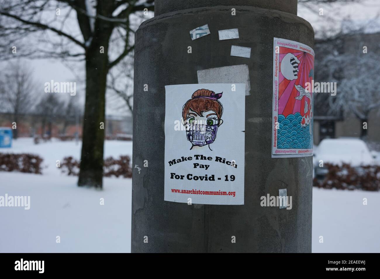 Glasgow, UK, on 9 February 2021. A sticker by an anarchist group adorns a lampost, during the ongoing Covid-19 CoronaVirus health pandemic. Photo credit: Jeremy Sutton-Hibbert/ Alamy Live News. Stock Photo
