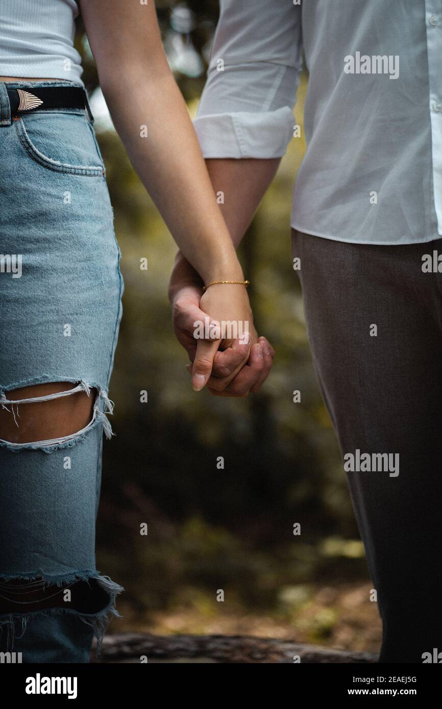 Closeup shot of couples walking hand in hand Stock Photo - Alamy