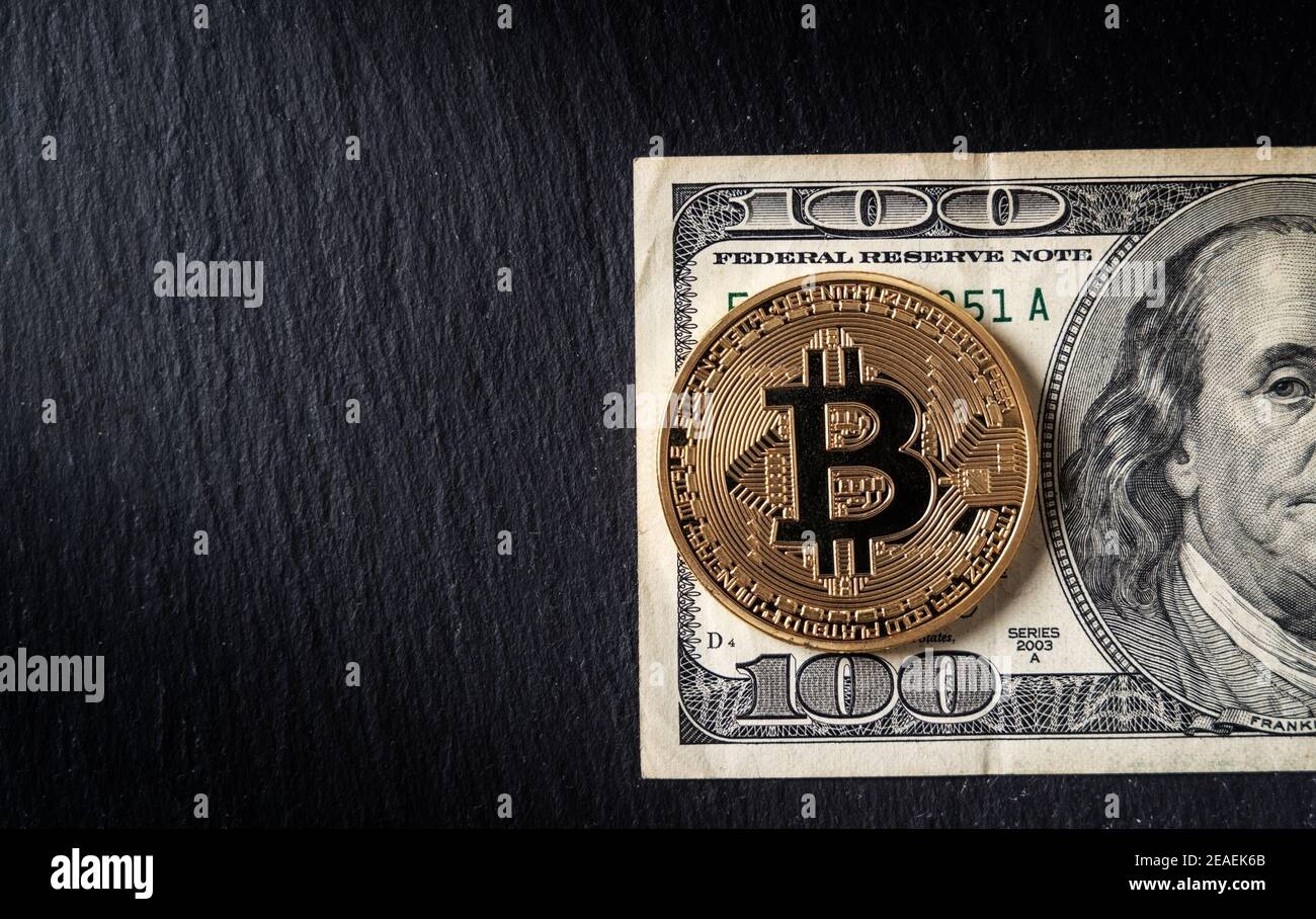 Bitcoin cryptocurrency equivalent to dollar, a banknote of one hundred  units. Future virtual currency concept. On a background of marble, close-up  Stock Photo - Alamy