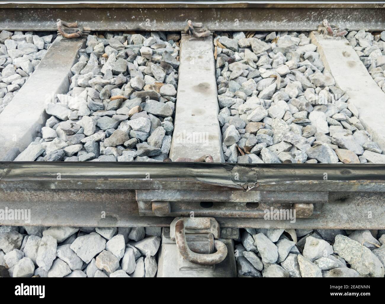 Broken railroad tracks at the inter-rail joints at risk of causing an accident, near the station in the city, front view with the copy space. Stock Photo