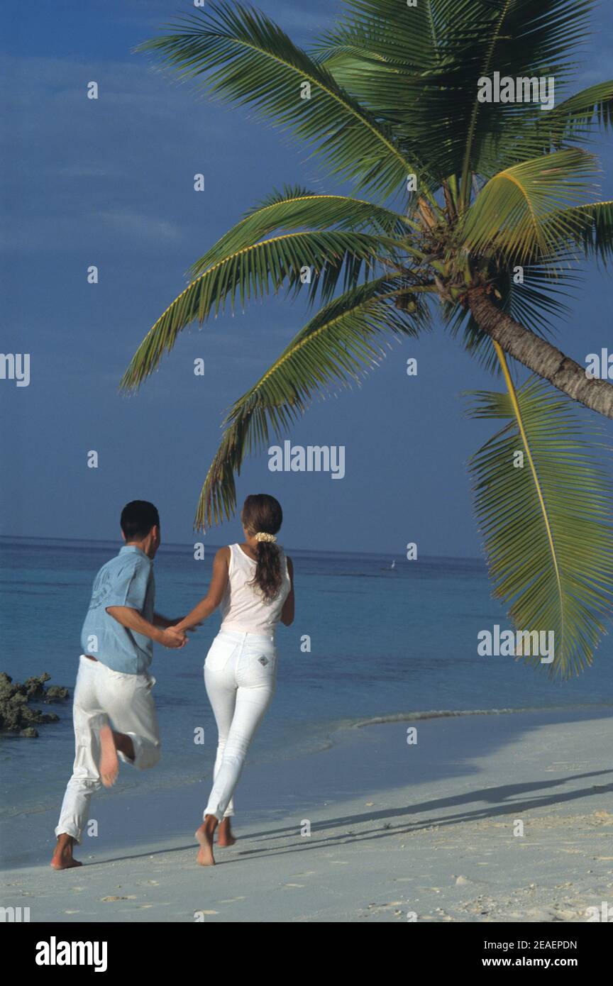 Maldives. Tropical beach. Young couple. Stock Photo