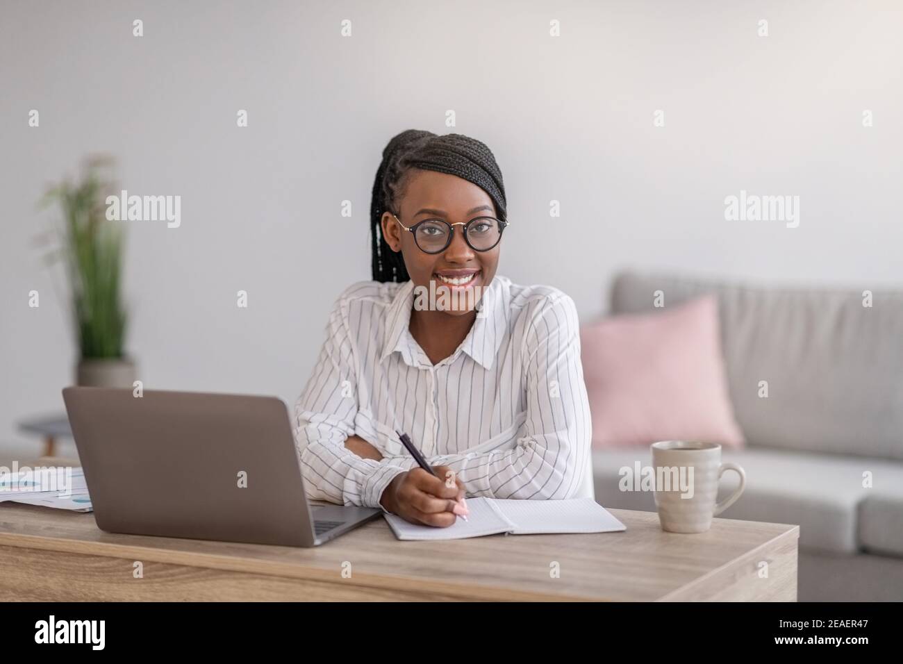 Positive black woman manager working from home Stock Photo - Alamy