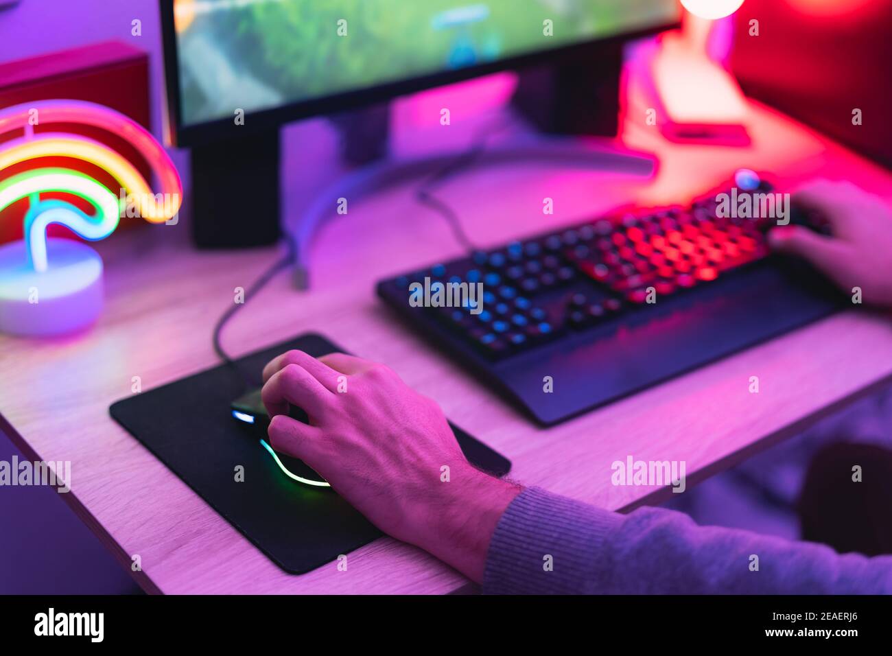 Young gamer playing online video games while streaming on social media ...